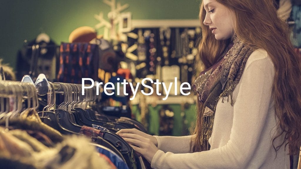 A young woman browsing a vintage clothing rack while learning how to shop thrift stores like a pro.