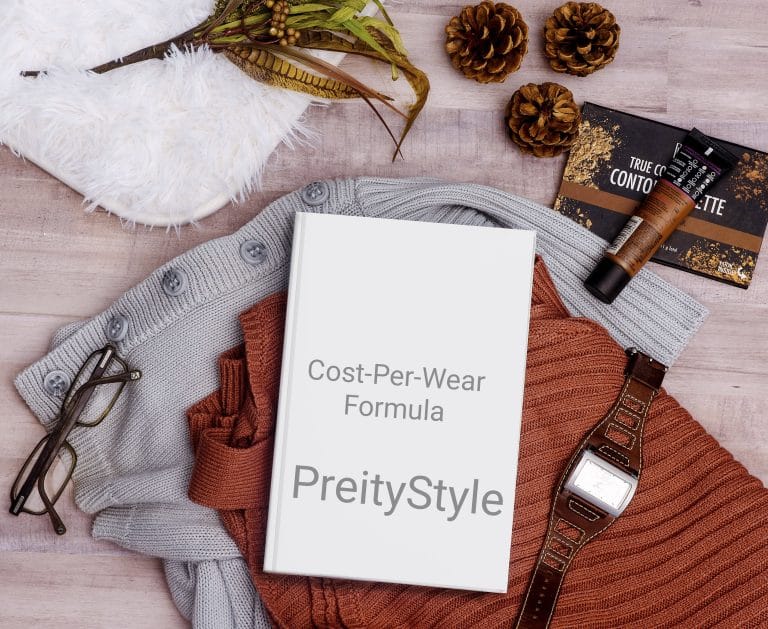 Flat lay setup of seasonal capsule wardrobe essentials illustrating how to calculate cost per wear